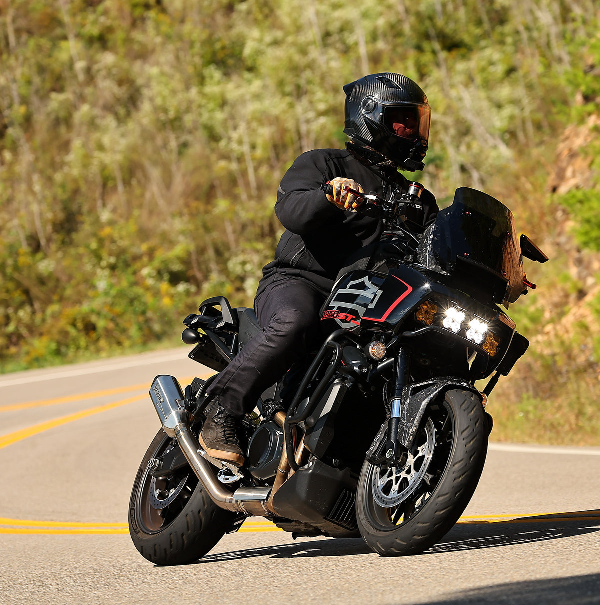 Rider cornering a Harley-Davidson Pan America fitted with a Stealth Pipes slip-on exhaust, photo 2 of 17