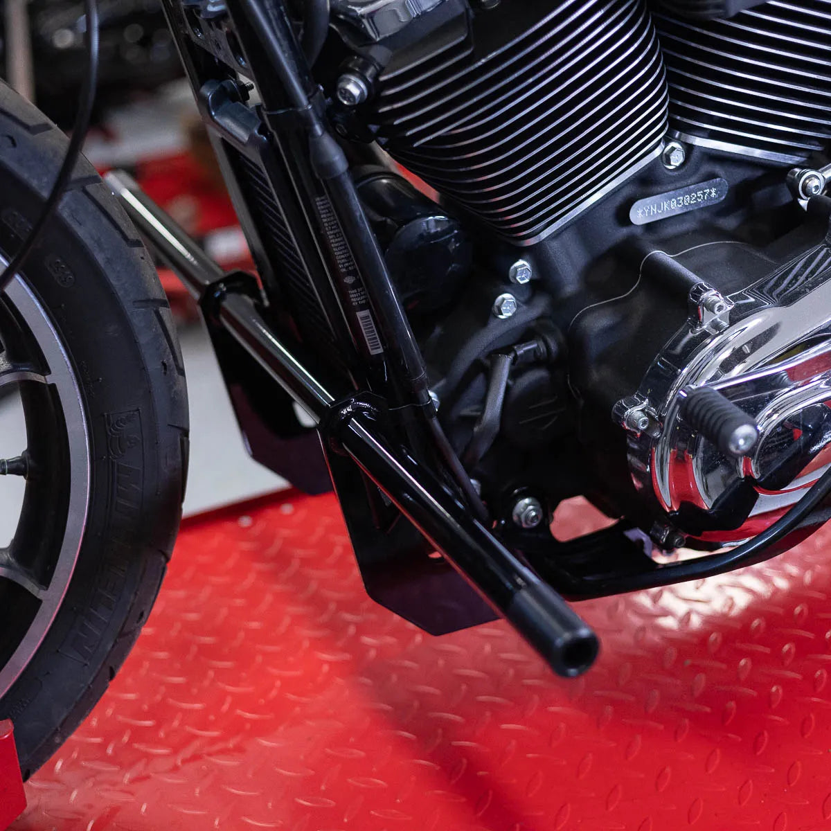 A black Softail Front Crash Bar designed for motorcycles, displayed installed on motorcycle., photo 2 of 10