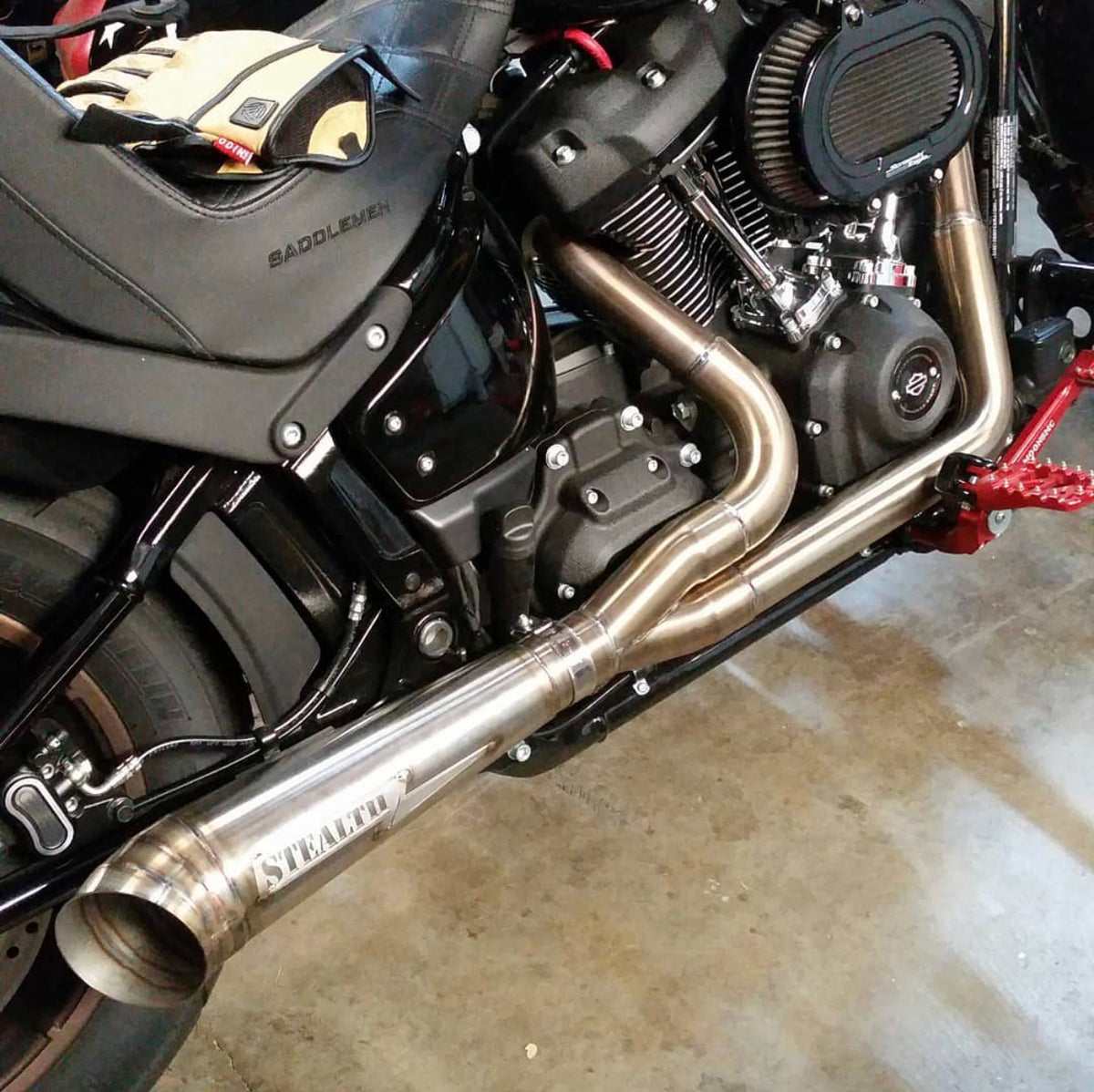 Stealth Pipes exhaust system installed on Harley M8 Softail – rear-side view of muffler and headers (2017–2025), photo 15 of 36