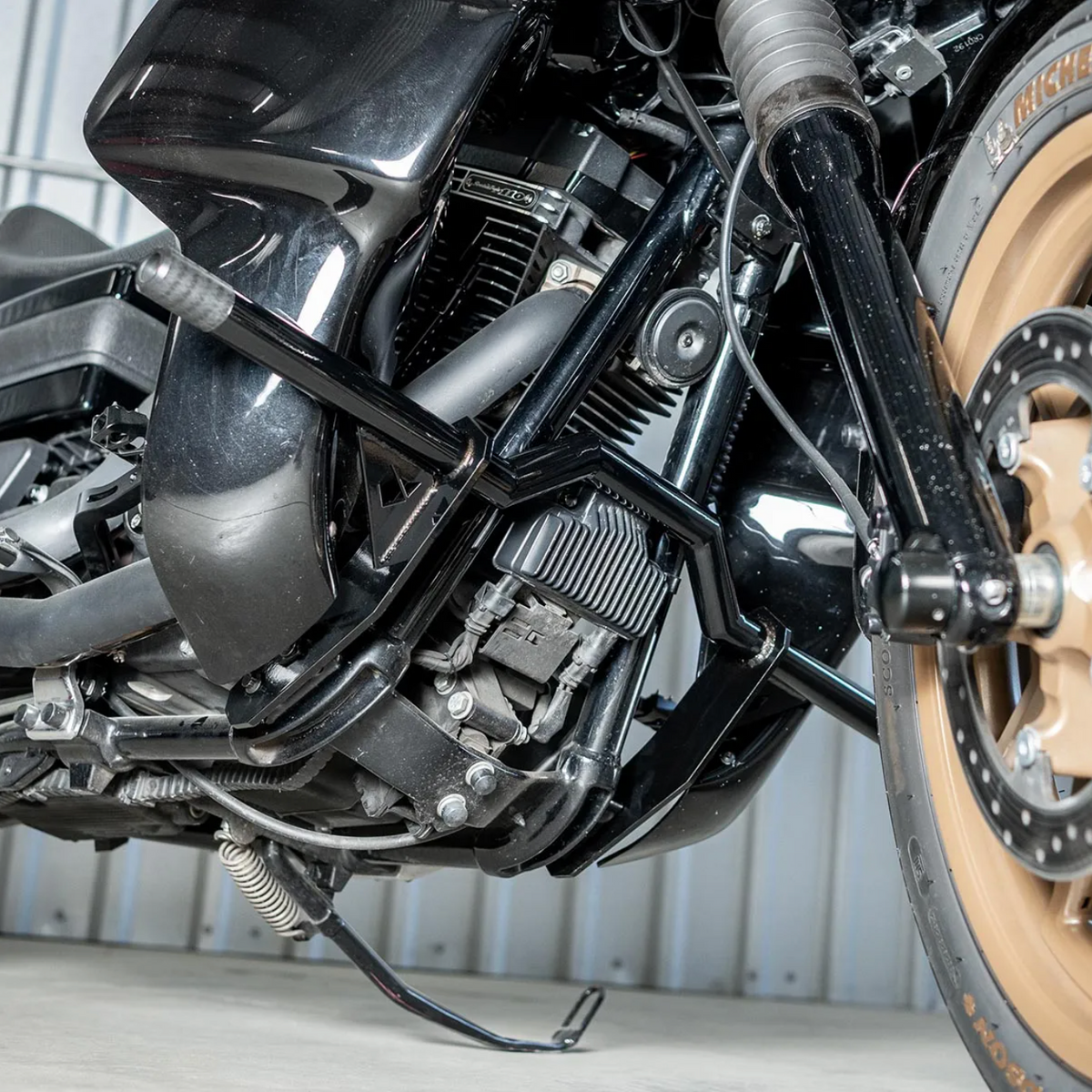 A black motorcycle crash bar installed on a motorcycle, designed to protect the paint job during falls or tipovers., photo 3 of 6