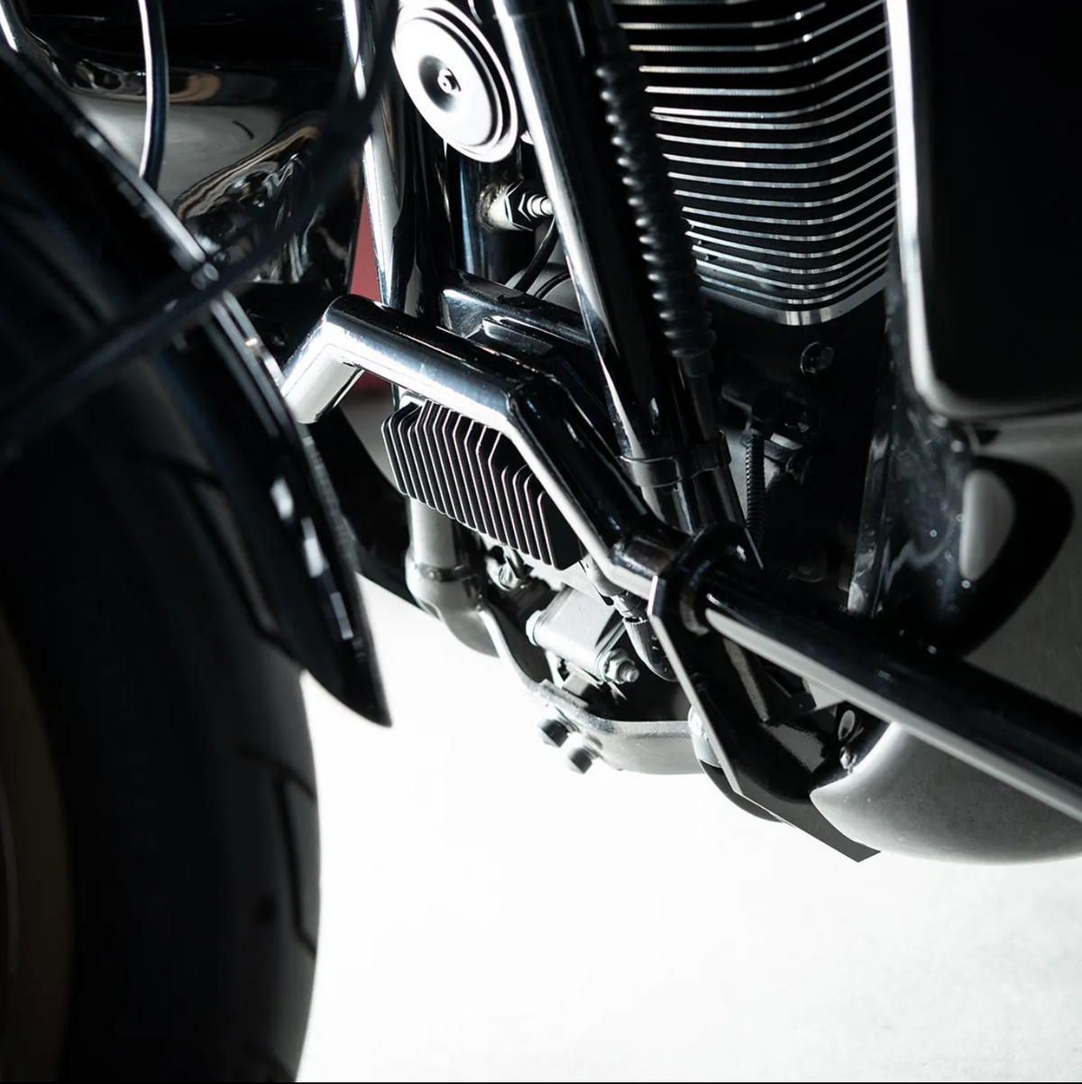 A black motorcycle crash bar installed on a motorcycle, designed to protect the paint job during falls or tipovers., photo 5 of 6