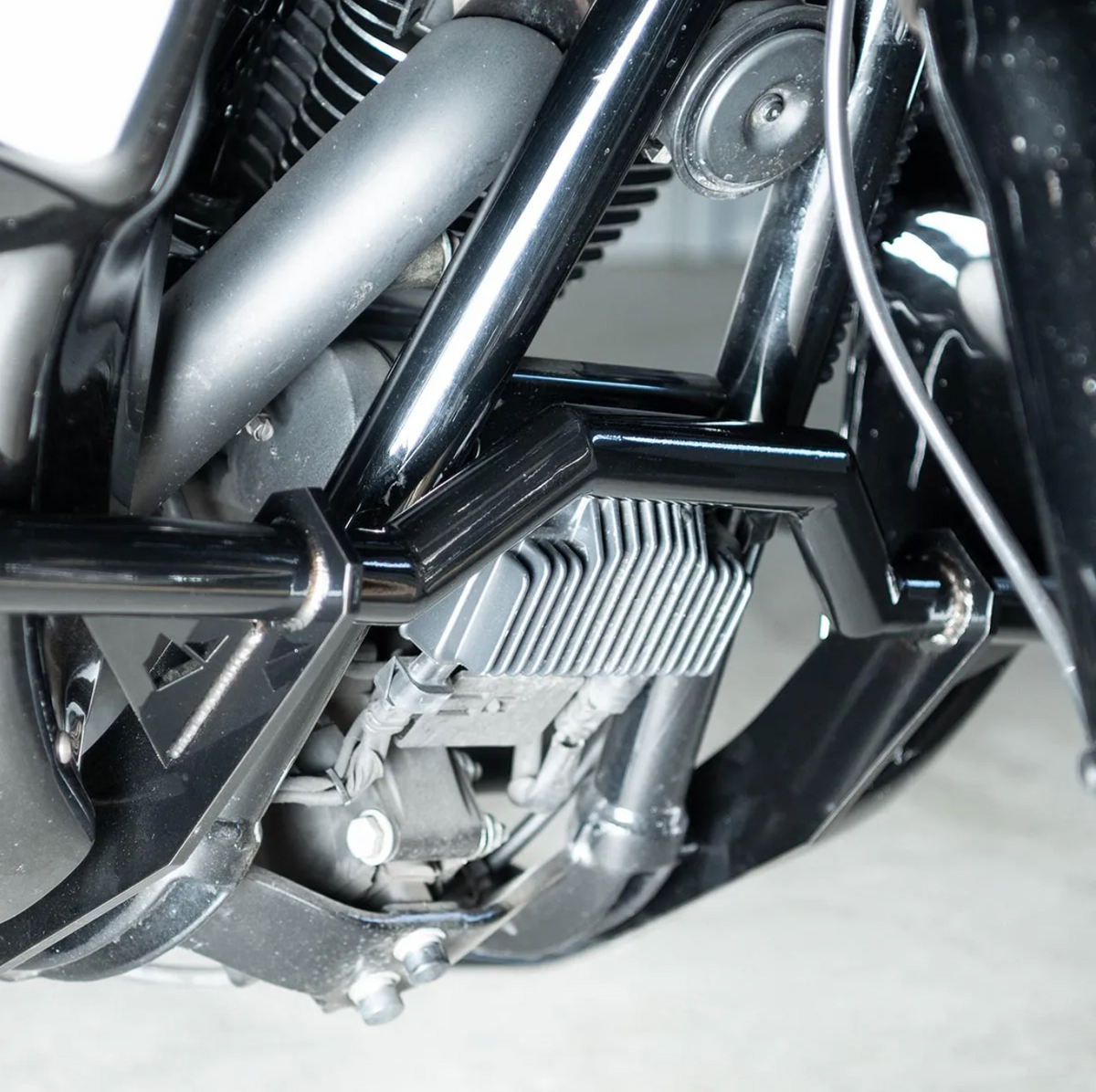 A black motorcycle crash bar installed on a motorcycle, designed to protect the paint job during falls or tipovers., photo 4 of 6