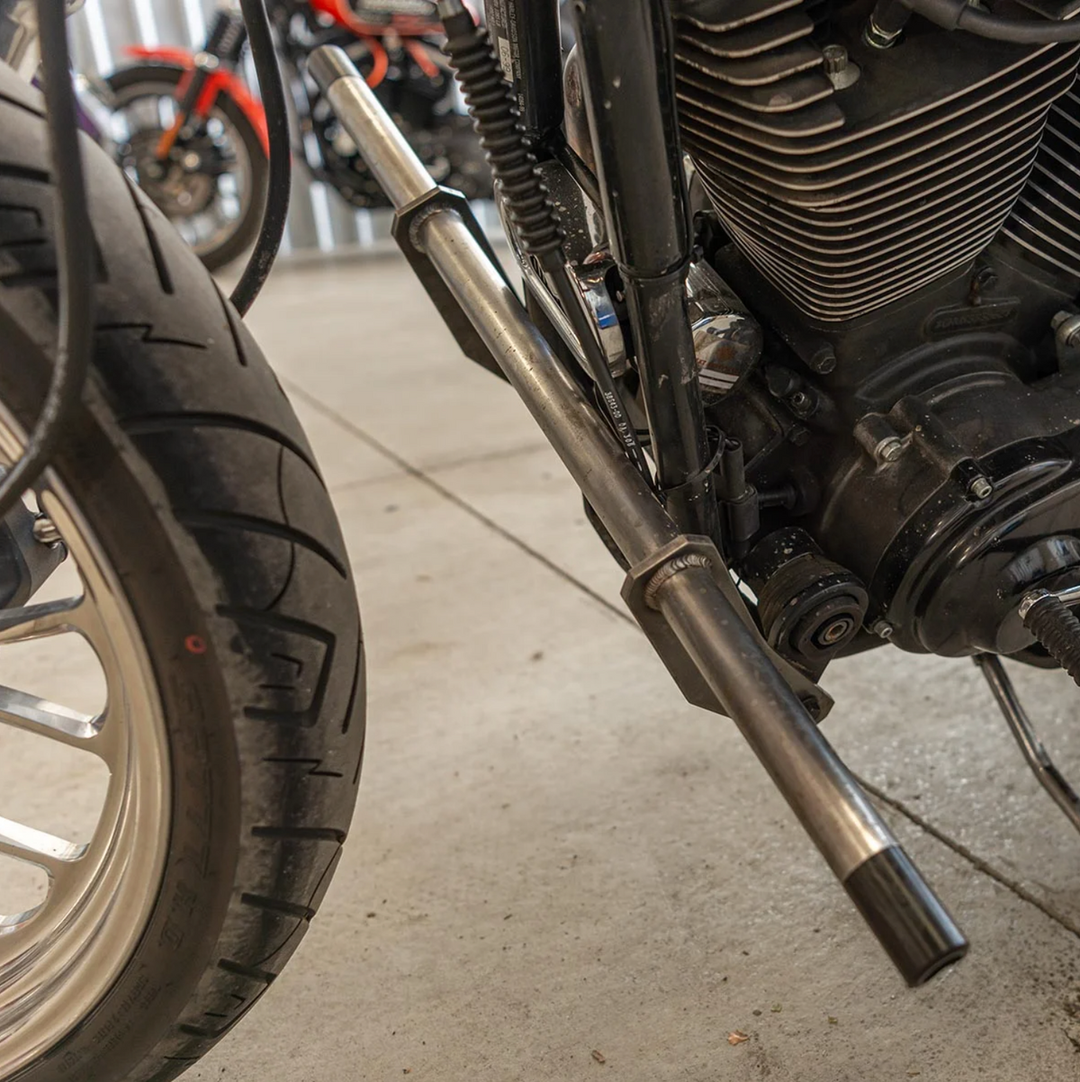 A black metal Dyna Crash Bar designed for motorcycle stunt riding, includes two Delrin sliders, displayed on a white background., photo 4 of 5