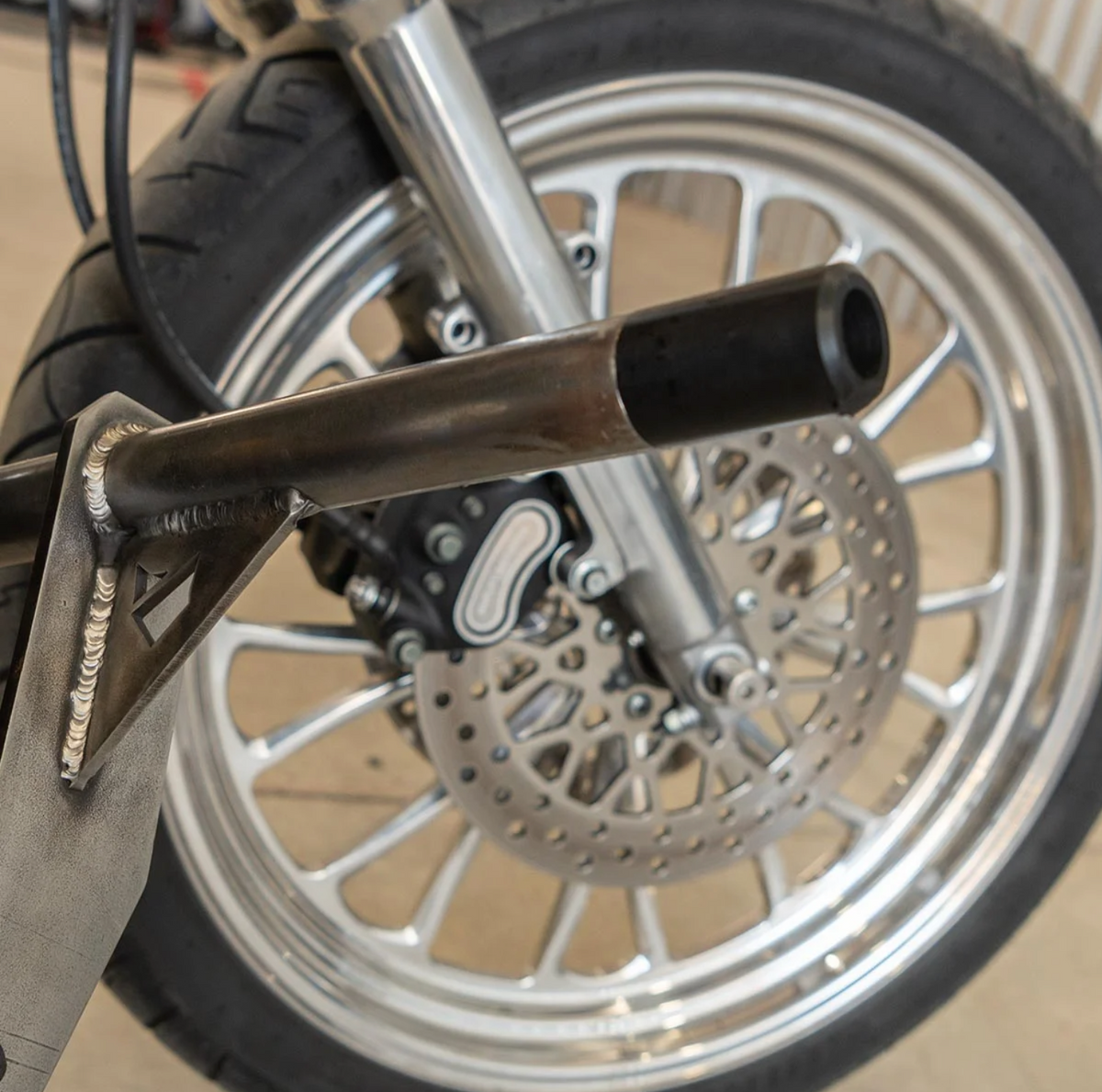 A black metal Dyna Crash Bar designed for motorcycle stunt riding, includes two Delrin sliders, displayed on a white background., photo 3 of 5