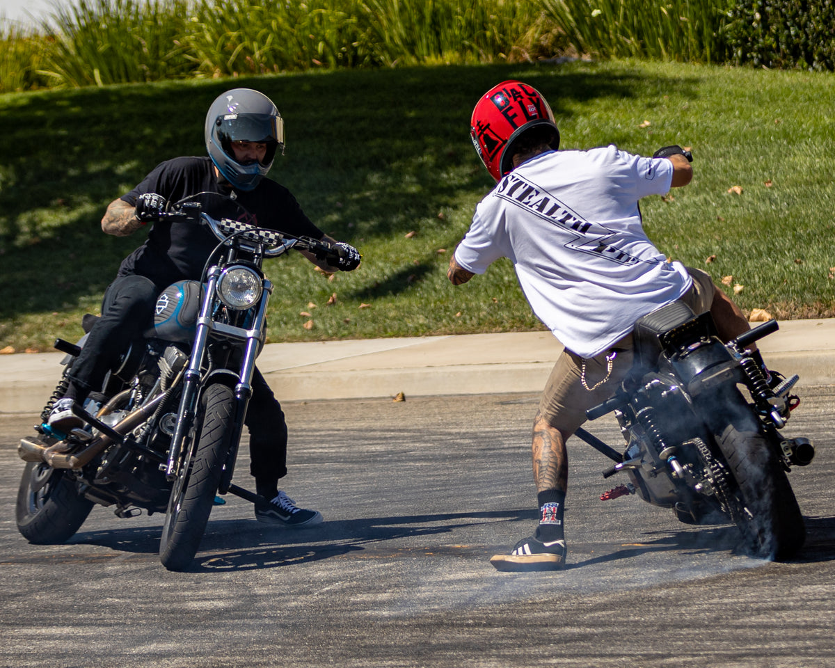 Motorcycle rider in Stealth Rider T-shirt captured from behind while riding, photo 3 of 4